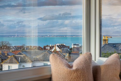 window seat with cushions and a sea view