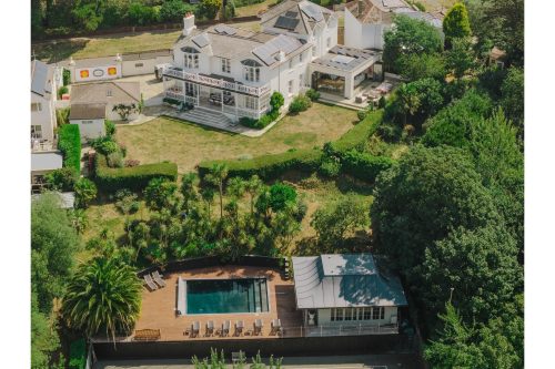 large luxury home with swimming pool and tennis courts