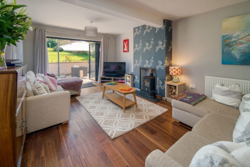 Large sitting room with bifold doors onto the patio