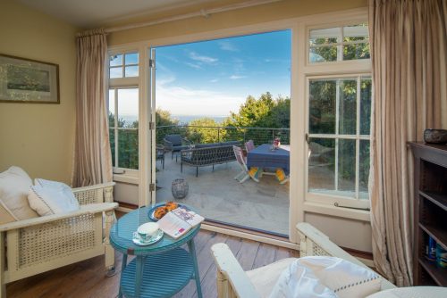 patio doors with two arm chairs out the doors onto the patio