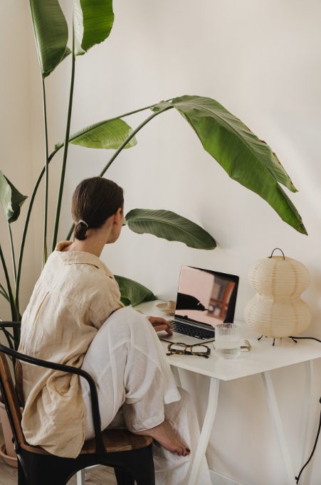 women sat at her computer and desk filing for registration