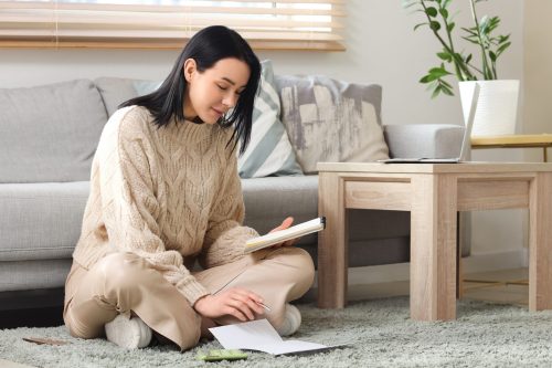 women sat on the floor making calculations