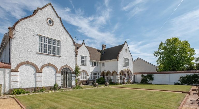 large house with lawn and walled garden