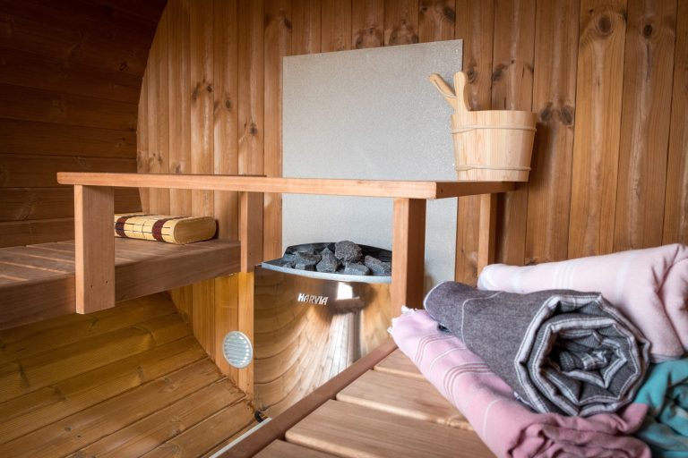 inside of a sauna with bucket and coals and towels