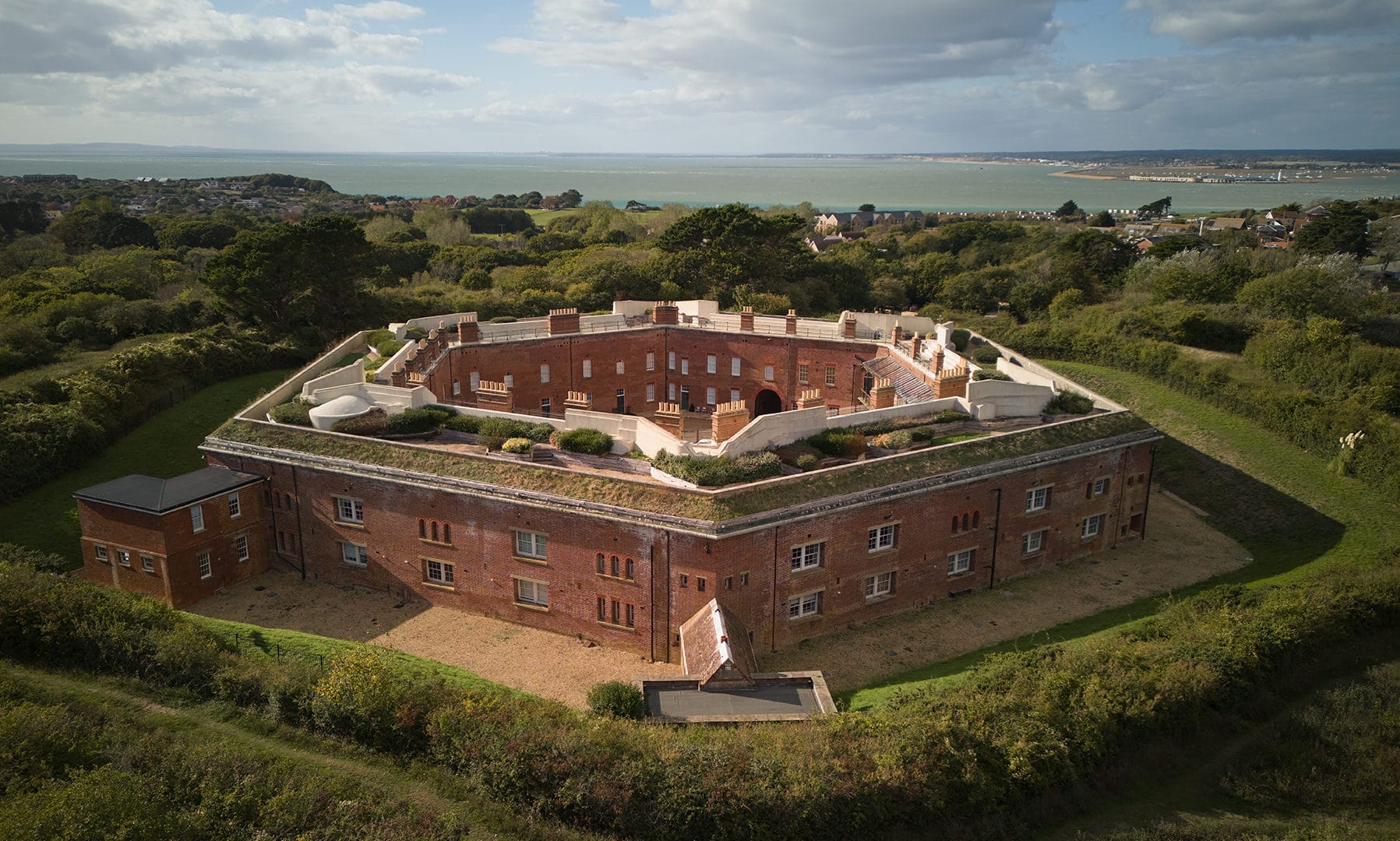 an octagonal fort with the horizon over the sea in the background